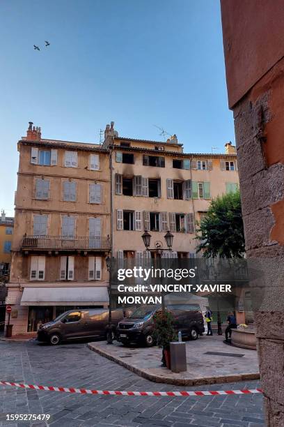 This photograph shows the burnt facade of a five-storey building in the historic centre of Grasse, on August 13 after at least three people were...