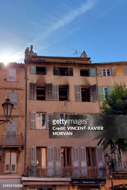 This photograph shows the burnt facade of a five-storey building in the historic centre of Grasse, on August 13 after at least three people were...