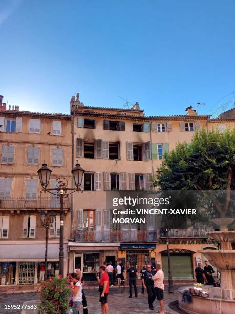 This photograph shows the burnt facade of a five-storey building in the historic centre of Grasse, on August 13 after at least three people were...