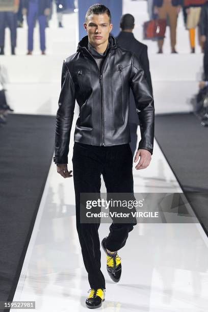 Model walks the runway during the Dirk Bikkembergs Ready to Wear Fall/Winter 2013-2014 how as part of Milan Fashion Week Menswear Autumn/Winter 2013...