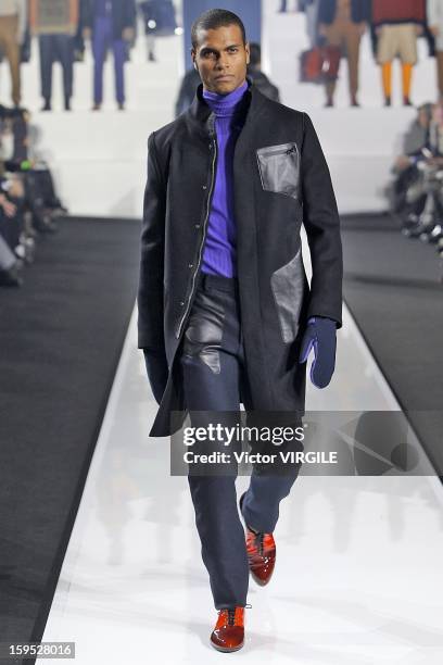 Model walks the runway during the Dirk Bikkembergs Ready to Wear Fall/Winter 2013-2014 how as part of Milan Fashion Week Menswear Autumn/Winter 2013...