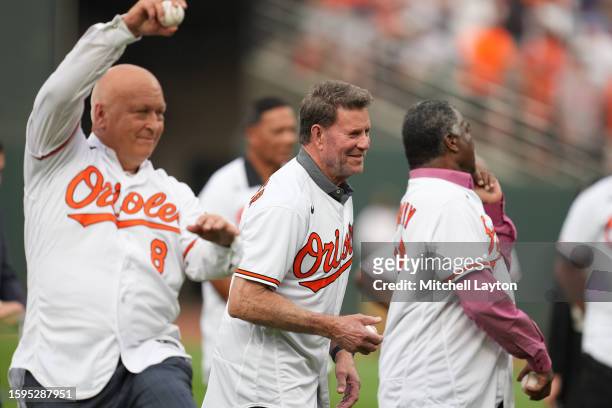 Former Baltimore Orioles Cal Ripken Jr,,Jim Palmer and Eddie Murray throw out the first pitch as part of the 40th World Series reunion before a...
