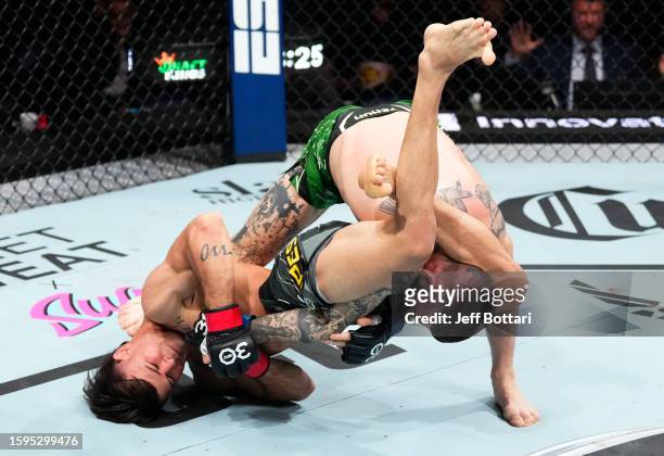 Diego Lopes of Brazil secures a triangle arm bar submission against Gavin Tucker of Canada in a featherweight fight during the UFC Fight Night event...