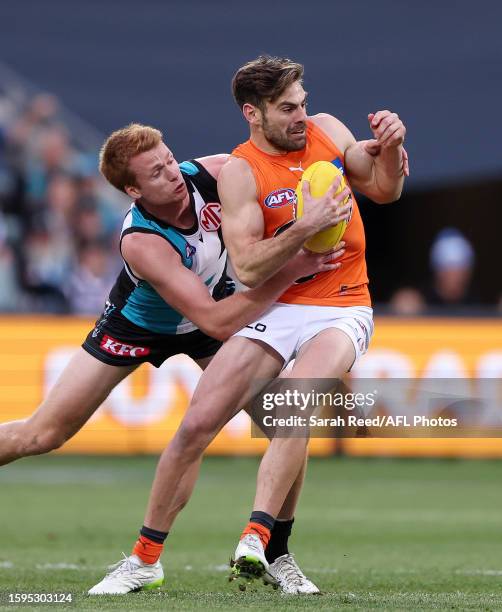 Stephen Coniglio of the Giants and Willem Drew of the Power during the 2023 AFL Round 22 match between the Port Adelaide Power and the GWS GIANTS at...