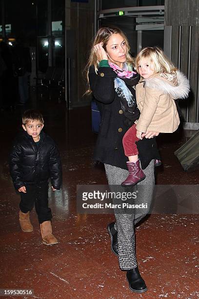 Christine Baumgartner, her son Hayes and her daughter Grace Avery are seen at Roissy airport on January 15, 2013 in Paris, France.