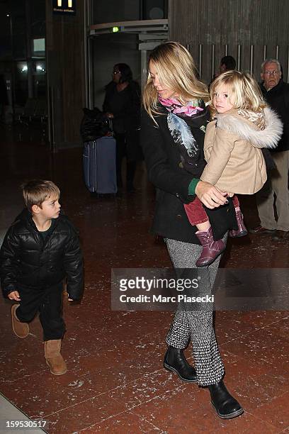 Christine Baumgartner, her son Hayes and her daughter Grace Avery are seen at Roissy airport on January 15, 2013 in Paris, France.