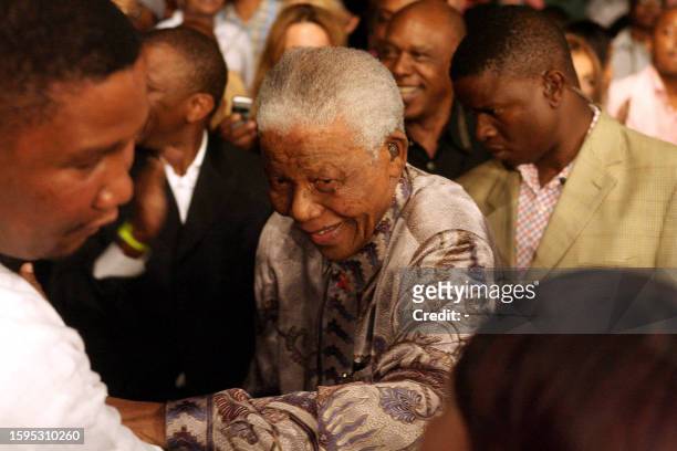 Former South African president Nelson Mandela, arrives at the ring side to watch Laila Ali, boxing champion and daughter of boxing legend Muhammad...
