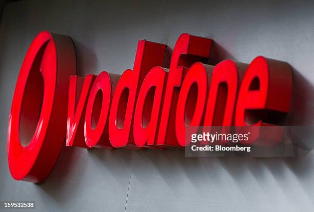 Logo sits on display outside a Vodafone Group Plc store in Barcelona, Spain, on Tuesday, Jan. 15, 2013. Vodafone Group Plc, the world's second...