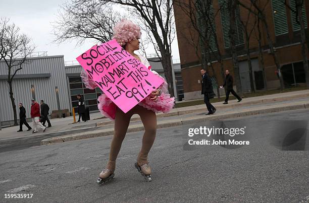 Protesters stage a demonstration outside the National Retail Federation convention after William Simon, president and CEO of U.S. Wal-Mart Stores Inc...