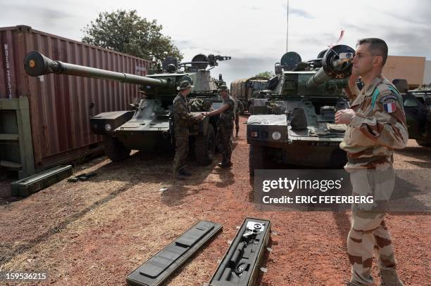 French army Legionnaire from the Licorne force based in Abidjan checks the cannon of a Sagaie tank on January 15, 2013 at the 101 military airbase...
