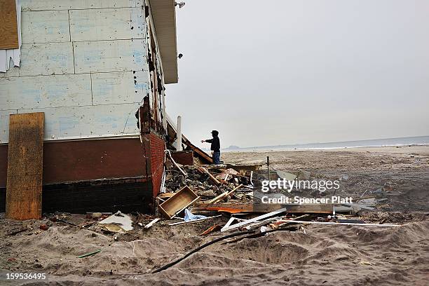 Contractor Rene Huerta looks at a damaged home he had been helping to remodel before Hurricane Sandy along the beach in the Rockaways on January 15,...