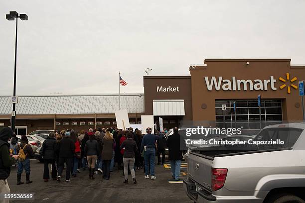 Protestors stand outside the Danbury Walmart January 15, 2013 in Danbury, Connecticut. Gun control advocates along with parents of victims and gun...