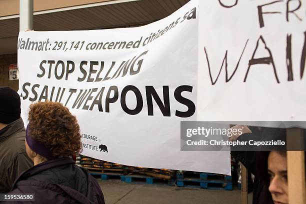 Protestors stand outside the Danbury Walmart January 15, 2013 in Danbury, Connecticut. Gun control advocates along with parents of victims and gun...