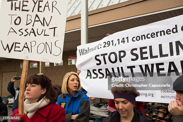Protestors stand outside the Danbury Walmart January 15, 2013 in Danbury, Connecticut. Gun control advocates along with parents of victims and gun...