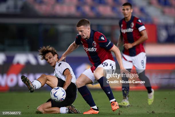 Lewis Ferguson of Bologna FC is tackled by Matteo Francesconi of Cesena FC during the Coppa Italia Frecciarossa football match between Bologna FC and...