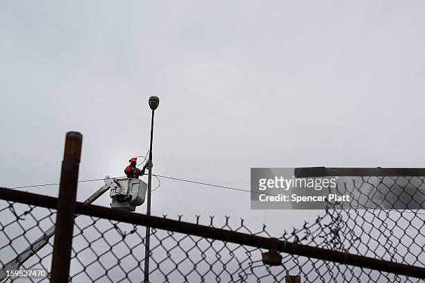 Street light damaged during Hurricane Sandy is repaired in the Rockaways on January 15, 2013 in New York City. A $50.7 billion Superstorm Sandy aid...
