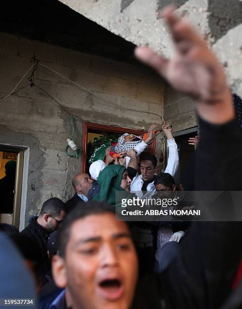 Relatives of Samir Ahmed Awad mourn his death during a funeral in the West Bank village of Budrus on January 15, 2013. Israeli troops shot dead a...