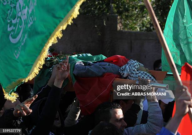Relatives of Samir Ahmed Awad take part in his funeral in the West Bank village of Budrus on January 15, 2013. Israeli troops shot dead a Palestinian...