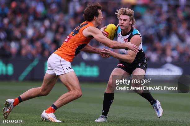Jack Buckley of the Giants tackles Jason Horne-Francis of the Power during the 2023 AFL Round 22 match between the Port Adelaide Power and the GWS...