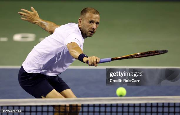 Daniel Evans of Great Britain returns a shot to Grigor Dimitrov of Bulgaria during Day 8 of the Mubadala Citi DC Open at Rock Creek Tennis Center on...