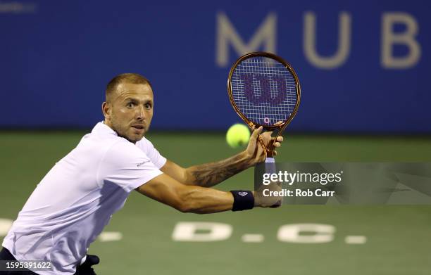 Daniel Evans of Great Britain returns a shot to Grigor Dimitrov of Bulgaria during Day 8 of the Mubadala Citi DC Open at Rock Creek Tennis Center on...