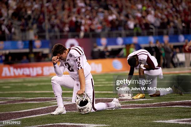 Cotton Bowl Classic: Texas A&M QB Johnny Manziel kneeling on field in prayer before game vs Oklahoma at Cowboys Stadium. Arlington, TX 1/4/2013...