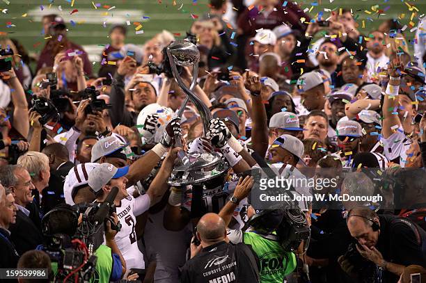 Cotton Bowl Classic: Texas A&M QB Johnny Manziel and teammates victorious on field with trophy after winning game vs Oklahoma at Cowboys Stadium....