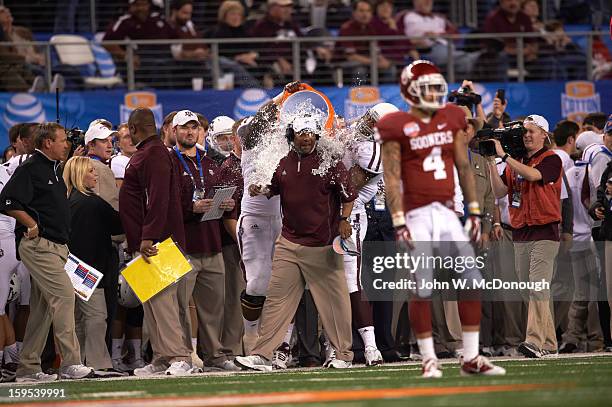 Cotton Bowl Classic: Texas A&M head coach Kevin Sumlin victorious as his players empty gatorade cooler on him after winning game vs Oklahoma at...