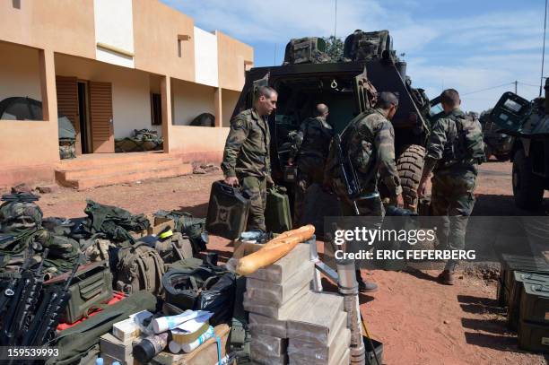 French troops load up their Sagaie armoured all terrain vehicles from the "Licorne" operation based in Abidjan at the 101 military airbase near...