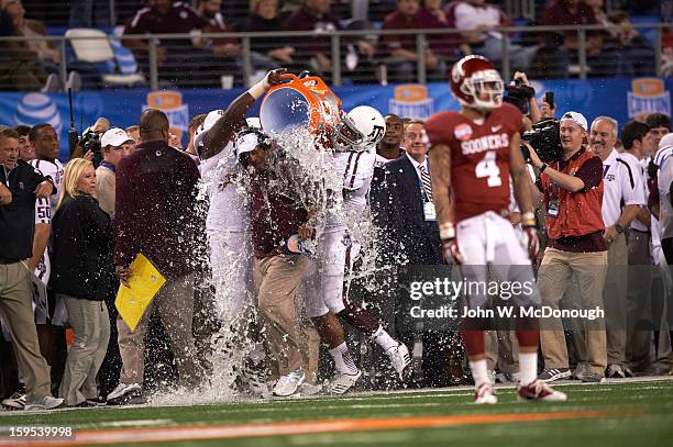 Cotton Bowl Classic: Texas A&M head coach Kevin Sumlin victorious as his players empty gatorade cooler on him after winning game vs Oklahoma at...
