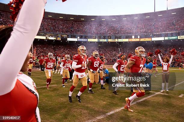 Playoffs: San Francisco 49ers QB Colin Kaepernick , QB Alex Smith , and teammates taking the field before game vs Green Bay Packers at Candlestick...