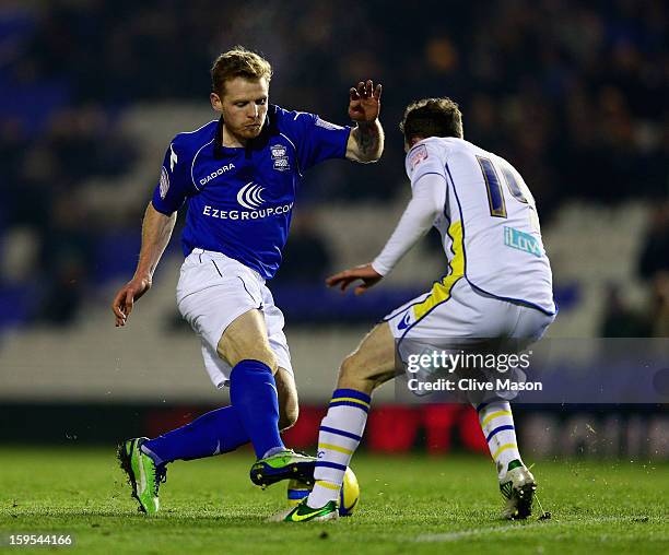 Chris Burke of Birmingham City is tackled by Aidy White of Leeds United during the FA Cup with Budweiser Third Round Replay match between Birmingham...