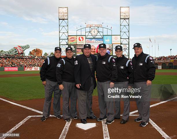 The umpiring crew poses for a photograph at home plate before Game One of the 2012 World Series between the Detroit Tigers and the San Francisco...