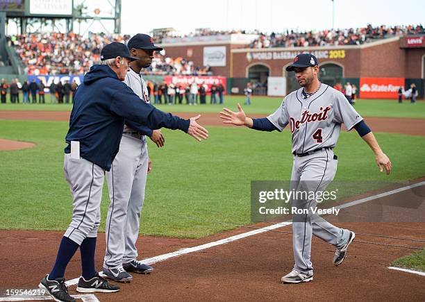 Jim Leyland manager of the Detroit Tigers shakes hands with Omar Infante of the Detroit Tigers during player introductions before Game One of the...