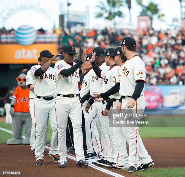 Joaquin Arias of the San Francisco Giants shakes hands with teammates during player introductions before Game One of the 2012 World Series between...