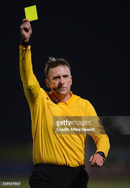 Referee Jon Moss issues a yellow card during the FA Cup Third Round Replay between AFC Bournemouth and Wigan Athletic at Goldsands Stadium on January...
