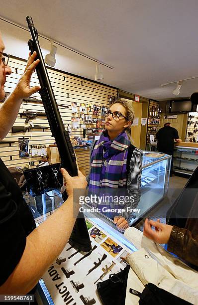 Naomi looks at a shotgun to purchase for home protection at the "Get Some Guns & Ammo" shooting range on January 15, 2013 in Salt Lake City, Utah....