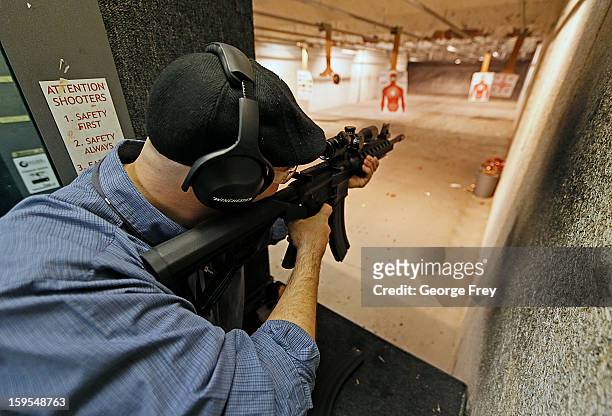 Man fires an 22 Cal. Look-alike AR-15 rifle at the "Get Some Guns & Ammo" shooting range on January 15, 2013 in Salt Lake City, Utah. Lawmakers are...