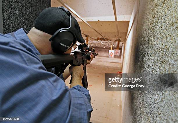 Man fires an 22 Cal. Look-alike AR-15 rifle at the "Get Some Guns & Ammo" shooting range on January 15, 2013 in Salt Lake City, Utah. Lawmakers are...