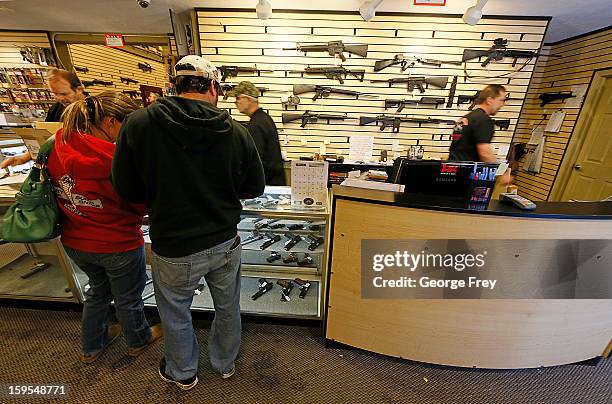 People look at various guns to purchase at the "Get Some Guns & Ammo" shooting range on January 15, 2013 in Salt Lake City, Utah. Lawmakers are...