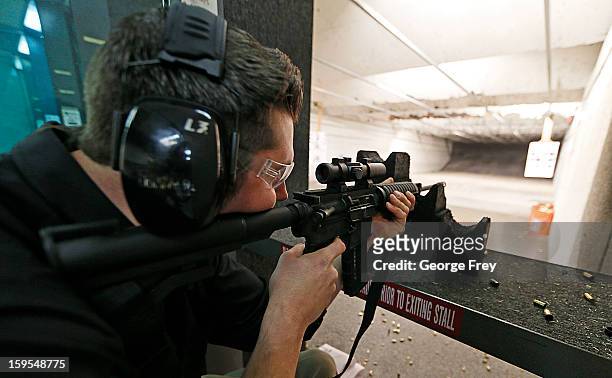 Brett Nielsen fires an AR-15 rifle at the "Get Some Guns & Ammo" shooting range on January 15, 2013 in Salt Lake City, Utah. Lawmakers are calling...