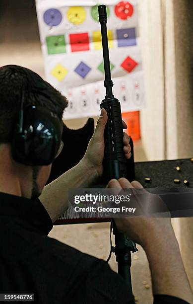 Brett Nielsen adjusts the sights of an AR-15 rifle at the "Get Some Guns & Ammo" shooting range on January 15, 2013 in Salt Lake City, Utah....