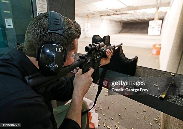 Brett Nielsen fires an AR-15 rifle at the "Get Some Guns & Ammo" shooting range on January 15, 2013 in Salt Lake City, Utah. Lawmakers are calling...