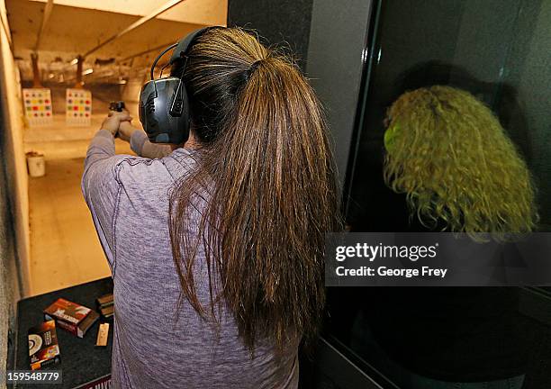 Two women fire handguns at the "Get Some Guns & Ammo" shooting range on January 15, 2013 in Salt Lake City, Utah. Lawmakers are calling for tougher...