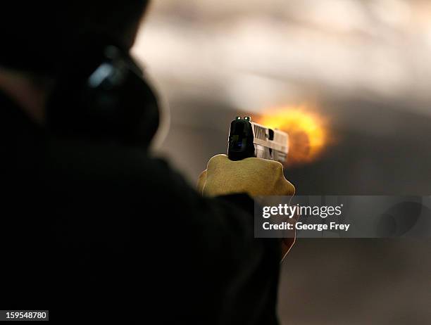 Brett Nielsen fires an Glock handgun at the "Get Some Guns & Ammo" shooting range on January 15, 2013 in Salt Lake City, Utah. Lawmakers are calling...