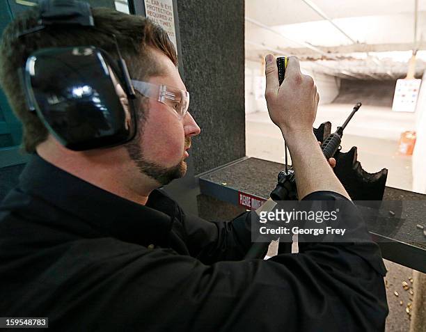 Brett Nielsen adjusts the sights of an AR-15 rifle at the "Get Some Guns & Ammo" shooting range on January 15, 2013 in Salt Lake City, Utah....