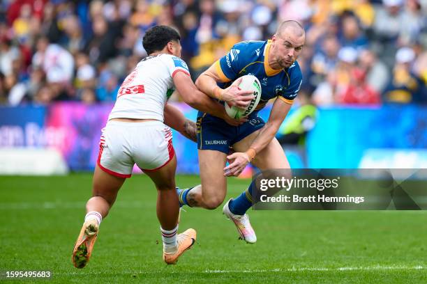 Clinton Gutherson of the Eels is tackled during the round 23 NRL match between Parramatta Eels and St George Illawarra Dragons at CommBank Stadium on...