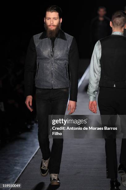 Model walks the runway during the Diesel Black Gold show as part of Milan Fashion Week Menswear Autumn/Winter 2013 on January 15, 2013 in Milan,...