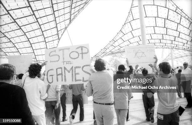 Demonstrators march in support of the Israili Olympic team and demand an end to the Games as 9 surviving members are being held hostage by members of...