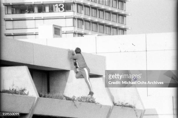 Track suited West German security official keeps and eye on the quarters of the Israili Olympic team where members of the Black September...